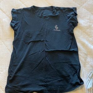 Black lululemon tee shirt with sun salutation wording on the front